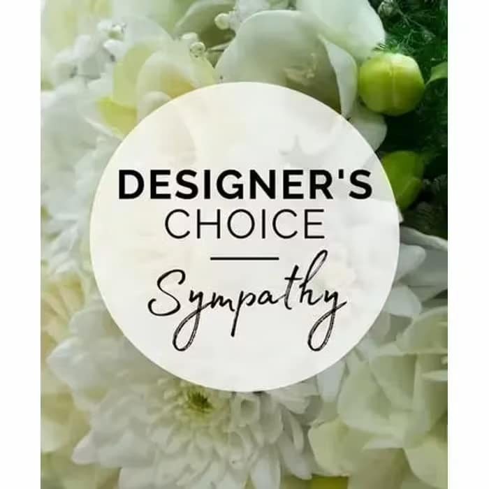 White floral sympathy arrangement with a designer's choice sign
