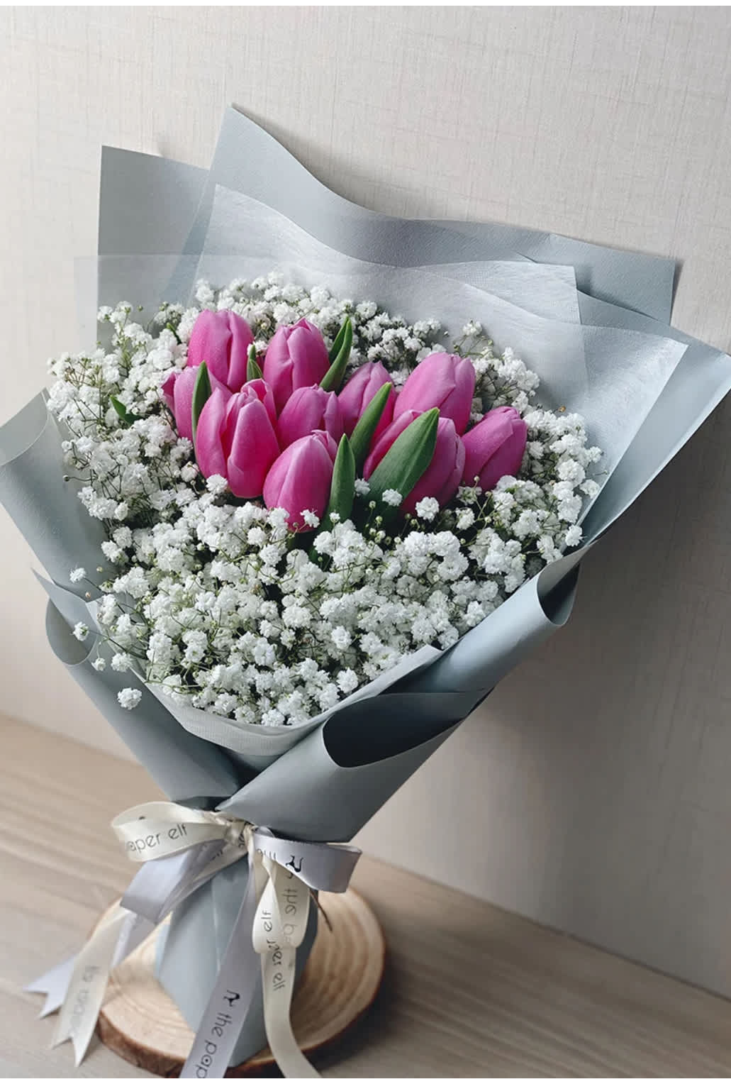 Bouquet of pink tulips surrounded by white baby's breath