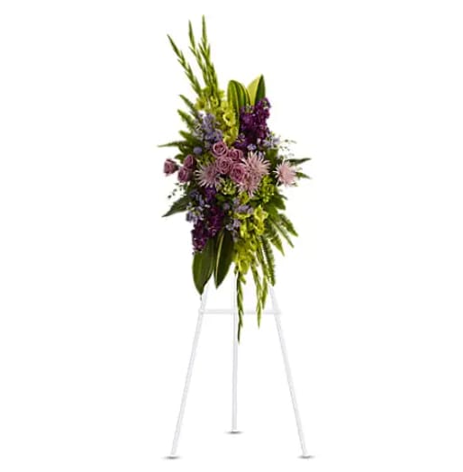 Tall purple and green floral standing spray on an easel