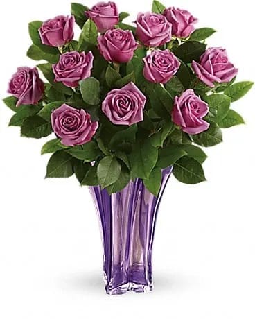 Purple rose bouquet in a tall purple glass vase