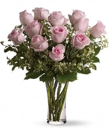 A Dozen Pink Roses - Pretty, pink and perfect. There's nothing like long-stemmed pink roses to show your affection. A dozen pink roses with variegated pittosporum and salal in a beautiful glass vase. 