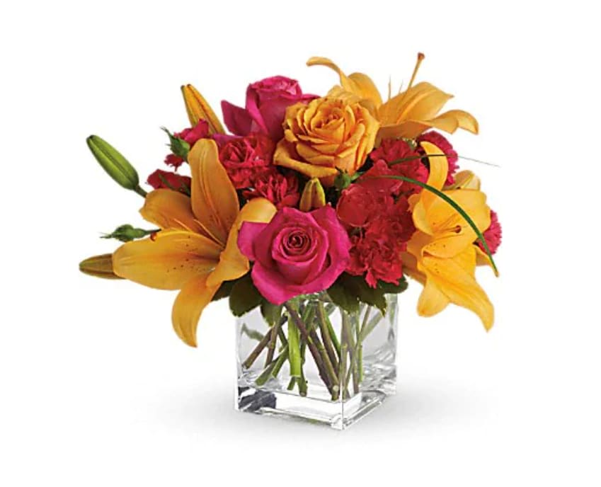 Uniquely Chic - Uniquely beautiful and uniquely bright, this is a bona fide bombshell of a bouquet. Brilliant blossoms are perfectly arranged in an exclusive cube vase. Orange roses, hot pink roses and spray roses are joined by glowing orange asiatic lilies and bear grass in a delightful vase. This unique arrangement is delivered in a cube but it's definitely not for squares.   Orientation : All-Around  All prices in USD ($)  Standard  T47-3A  Deluxe  T47-3B  Premium  T47-3C