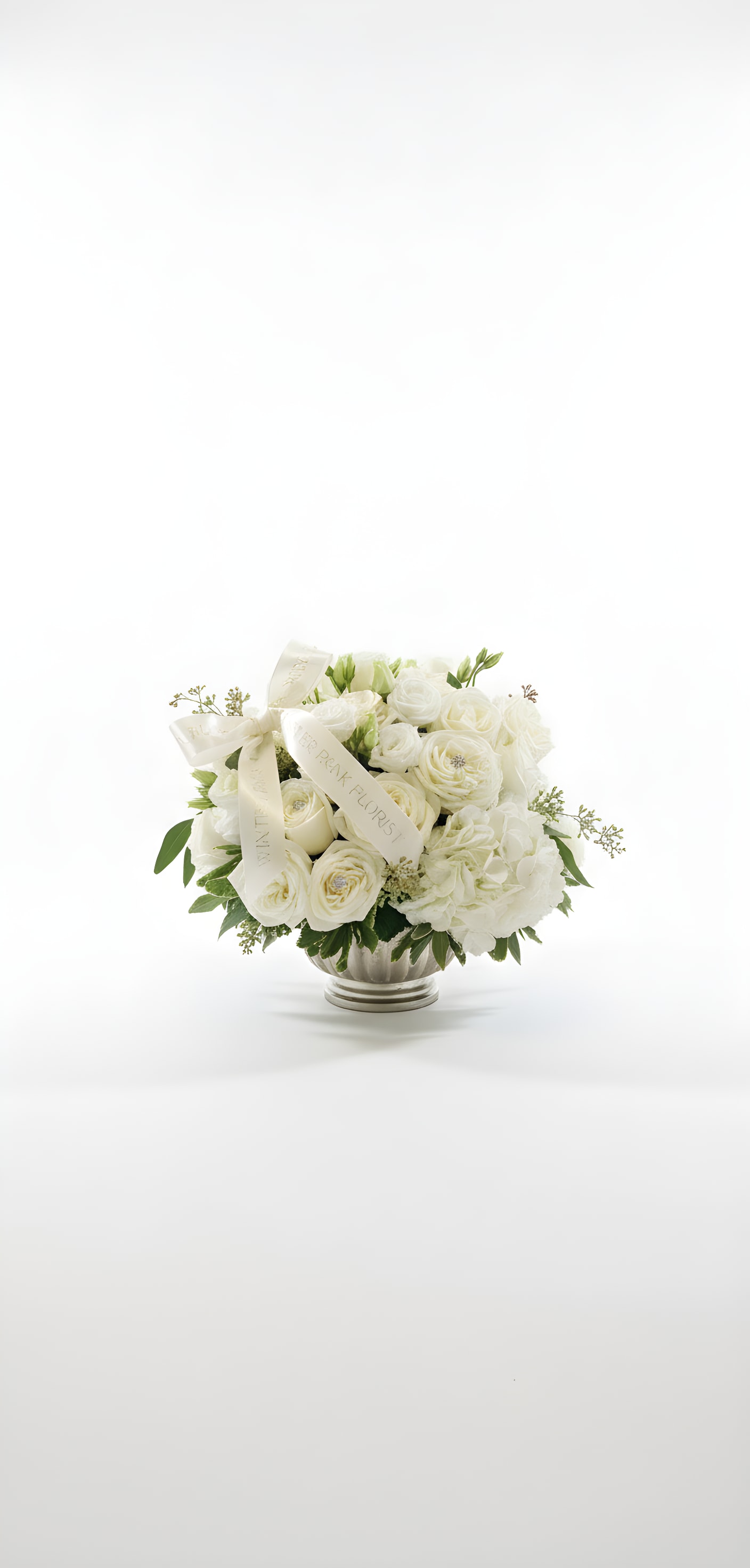 White rose bouquet in a silver vase with cream ribbons