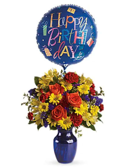 Birthday balloon above a colorful flower arrangement in a blue vase