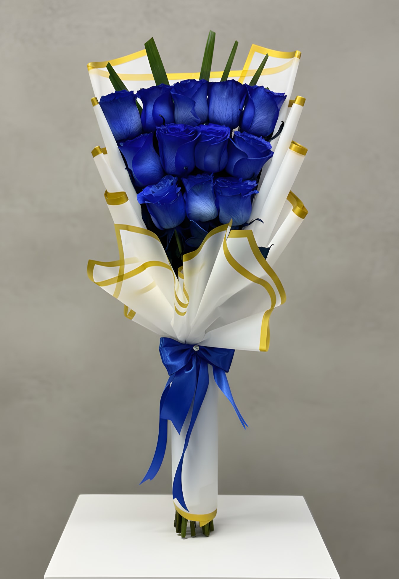 Wrapped Blue Roses Bouquet  - A captivating arrangement of fresh blue roses, elegantly wrapped and tied with a delicate satin ribbon. These striking blue blooms symbolize mystery, rarity, and heartfelt wishes, making this bouquet a perfect gift for birthdays, anniversaries, or to simply say you are one of a kind. STANDARD 12 ROSES PREMIUM 24 ROSES
