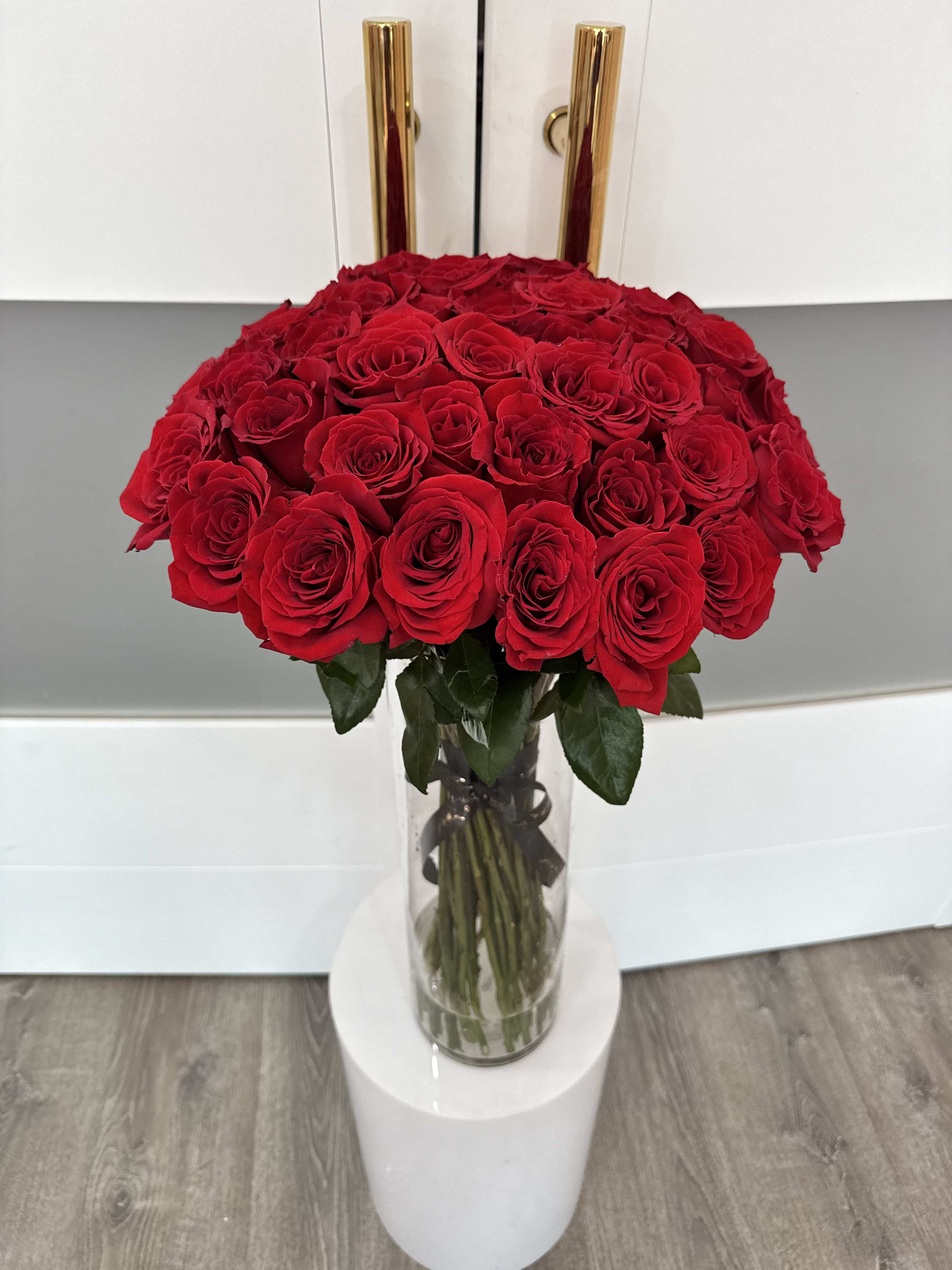 Large bouquet of red roses in a clear glass vase