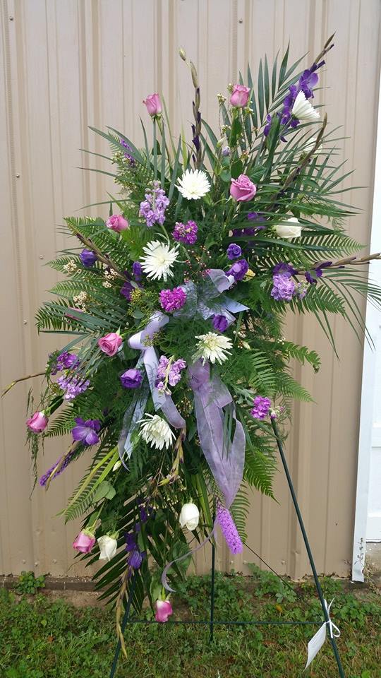 Tall standing floral spray with pink and purple flowers on a metal easel