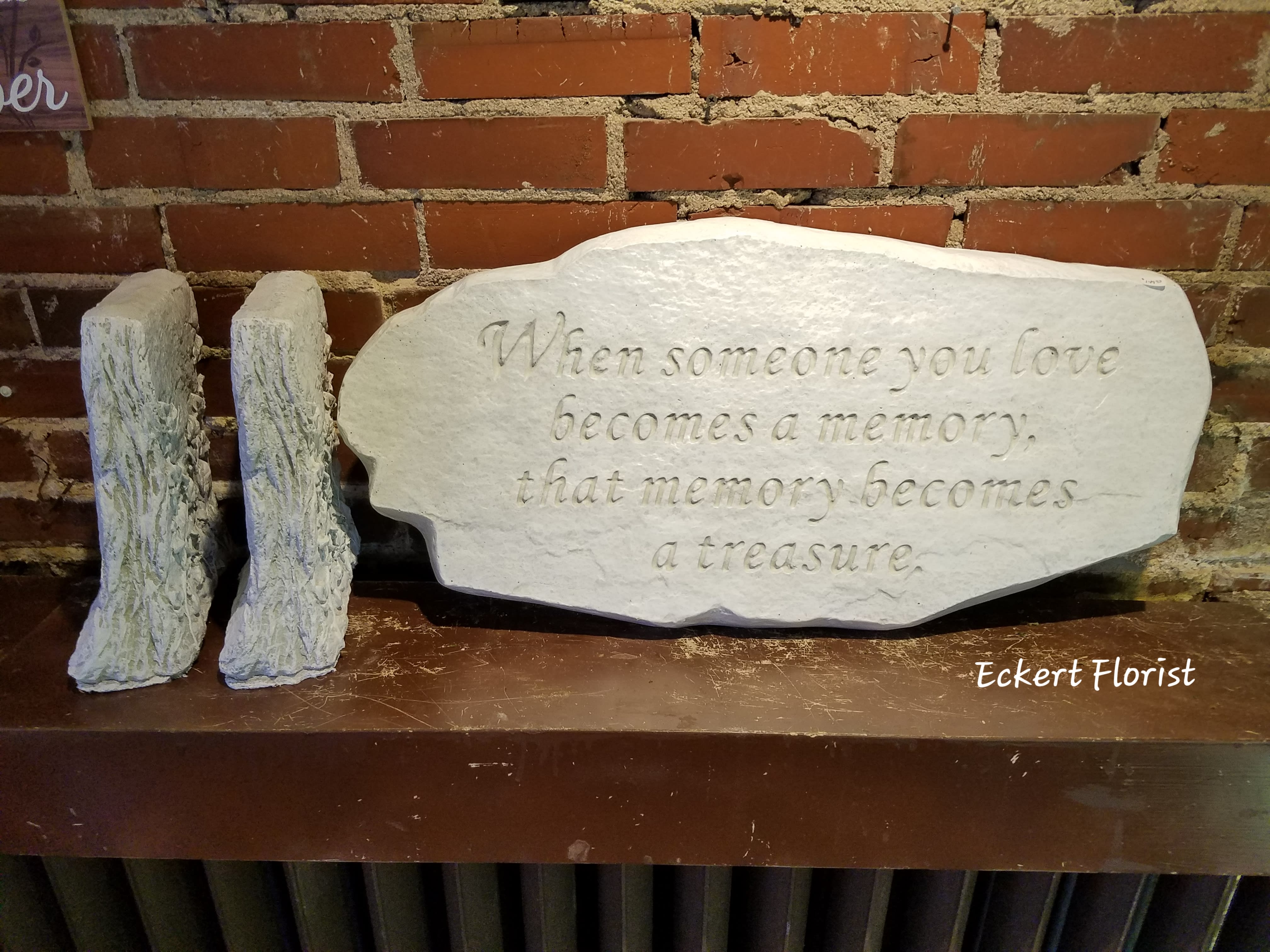 Eckert Florist's "When Someone You Love..." Stone Bench *LOCAL DELIVERRY ONLY - Stone Garden Bench ** LOCAL DELIVERY ONLY ** ALL OF OUR STONES COME DECORATED WITH A SHEER BOW, WILLOW, RAFFIA, AND OUR SIGNATURE BIRD. *NOTICE* Please call before ordering stones. Due to high demand, we may not have this particular stone in stock. If you would like to make sure we have this exact stone please call us at 618-233-9970. Or let us know in the order notes if something similar is OK.