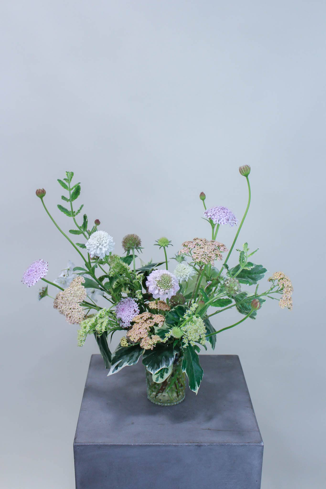 Garden Picked - Using texture, shape and color, this small wild flower bouquet is perfect for a thoughtful gift, the home, or office.   *Images are a representation of our design style. Each arrangement is made to order and will vary based on product availability the week of your order.