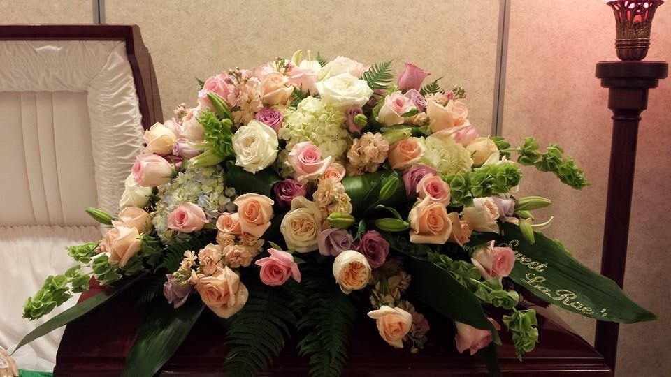 Timeless Devotion Casket Spray by Simply Flowers  - This absolutely stunning and fragrant casket spray is filled with fresh fresh roses, garden roses, hydrangea, bells of Ireland, asiatic lilies and lush greens. 