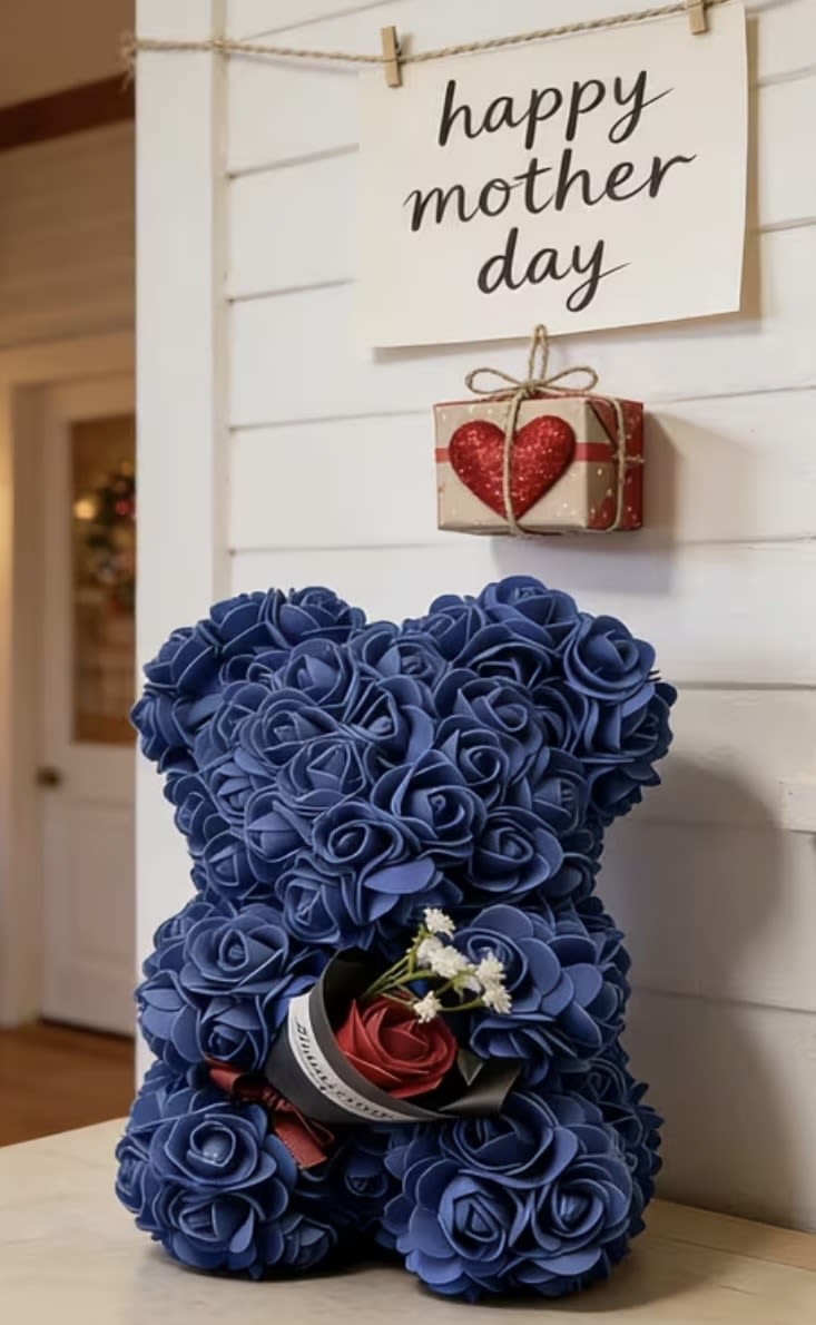 Blue teddy bear made of roses with a small gift box and Mother's Day sign