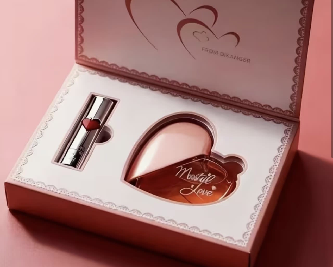 Pink gift box with a heart-shaped perfume bottle and lipstick