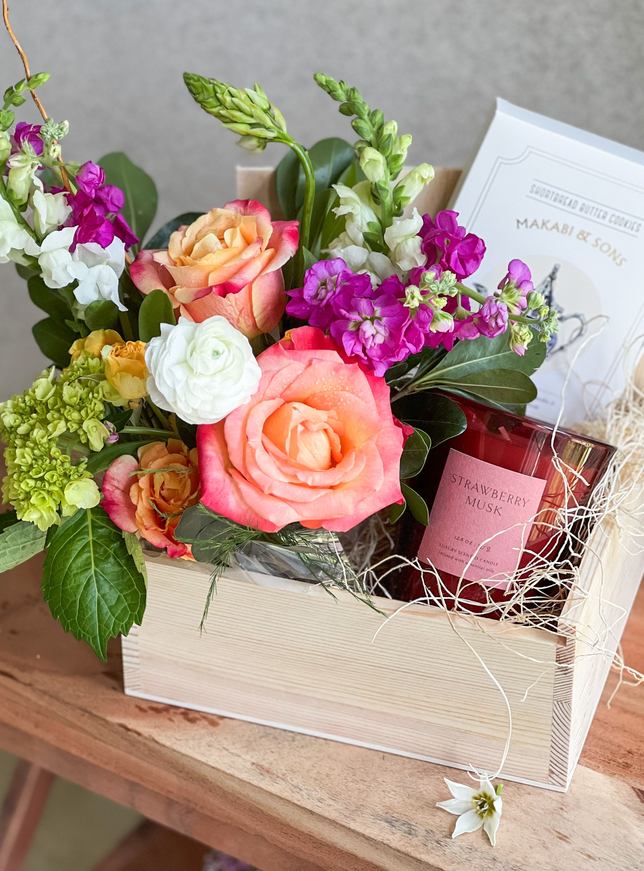 Mixed flower gift box with roses, stock, and a candle