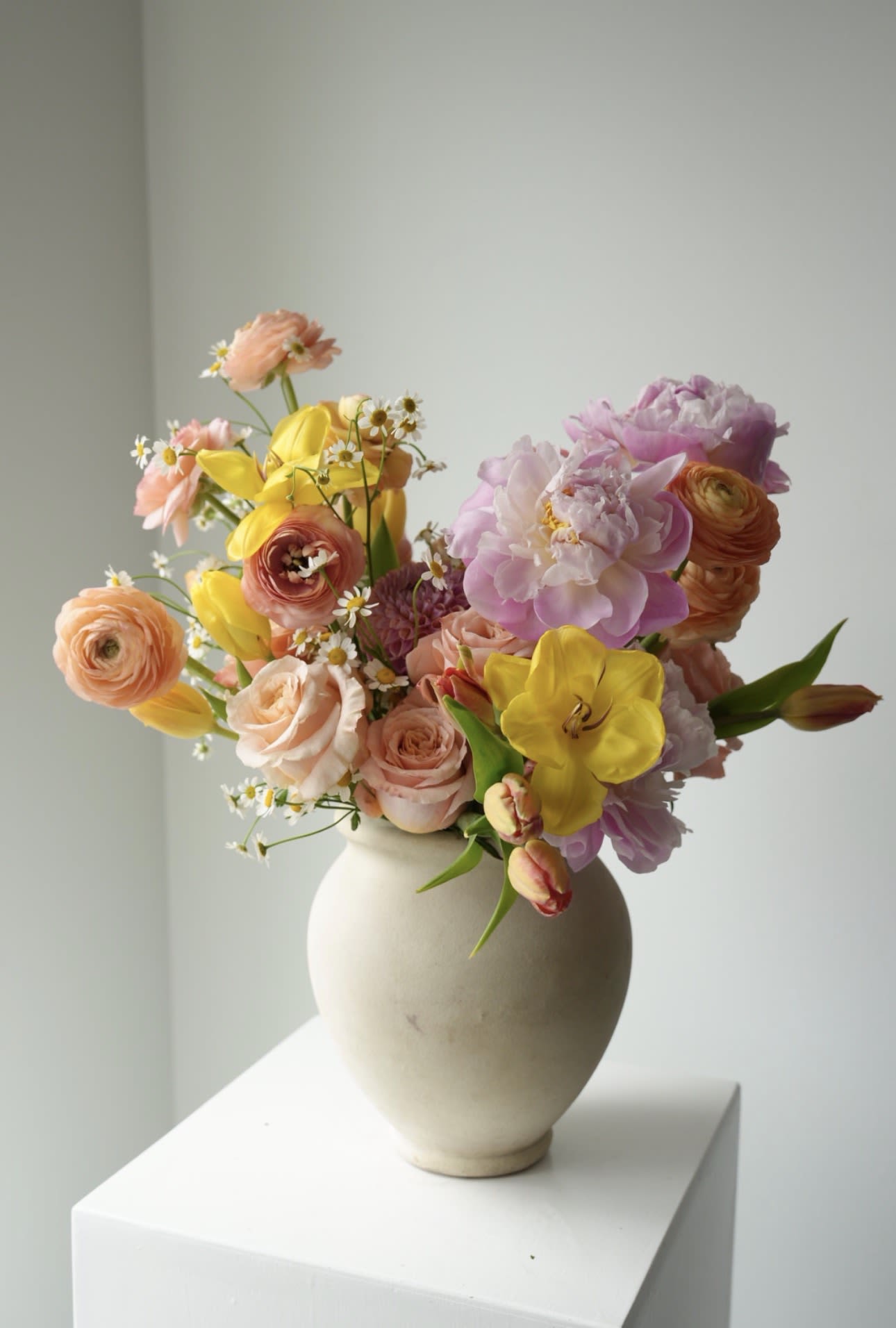 Dopamine Garden - A vibrant spring arrangement designed to bring instant joy. Featuring tulips, ranunculus, gerbera, hyacinth, and seasonal blooms in warm peach, yellow, and blush tones.  Fresh, playful, and full of light — a perfect way to brighten someone’s day and celebrate the season. 