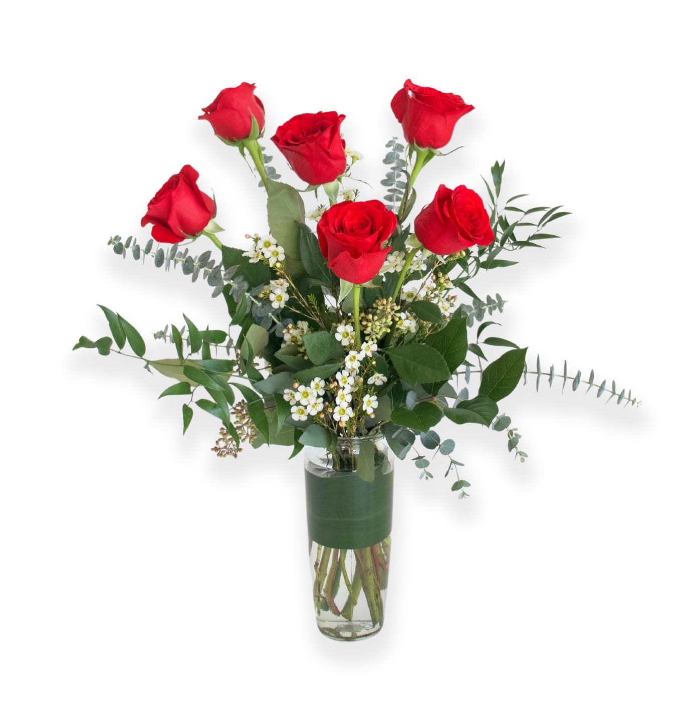 Red roses arranged in a clear glass vase with greenery