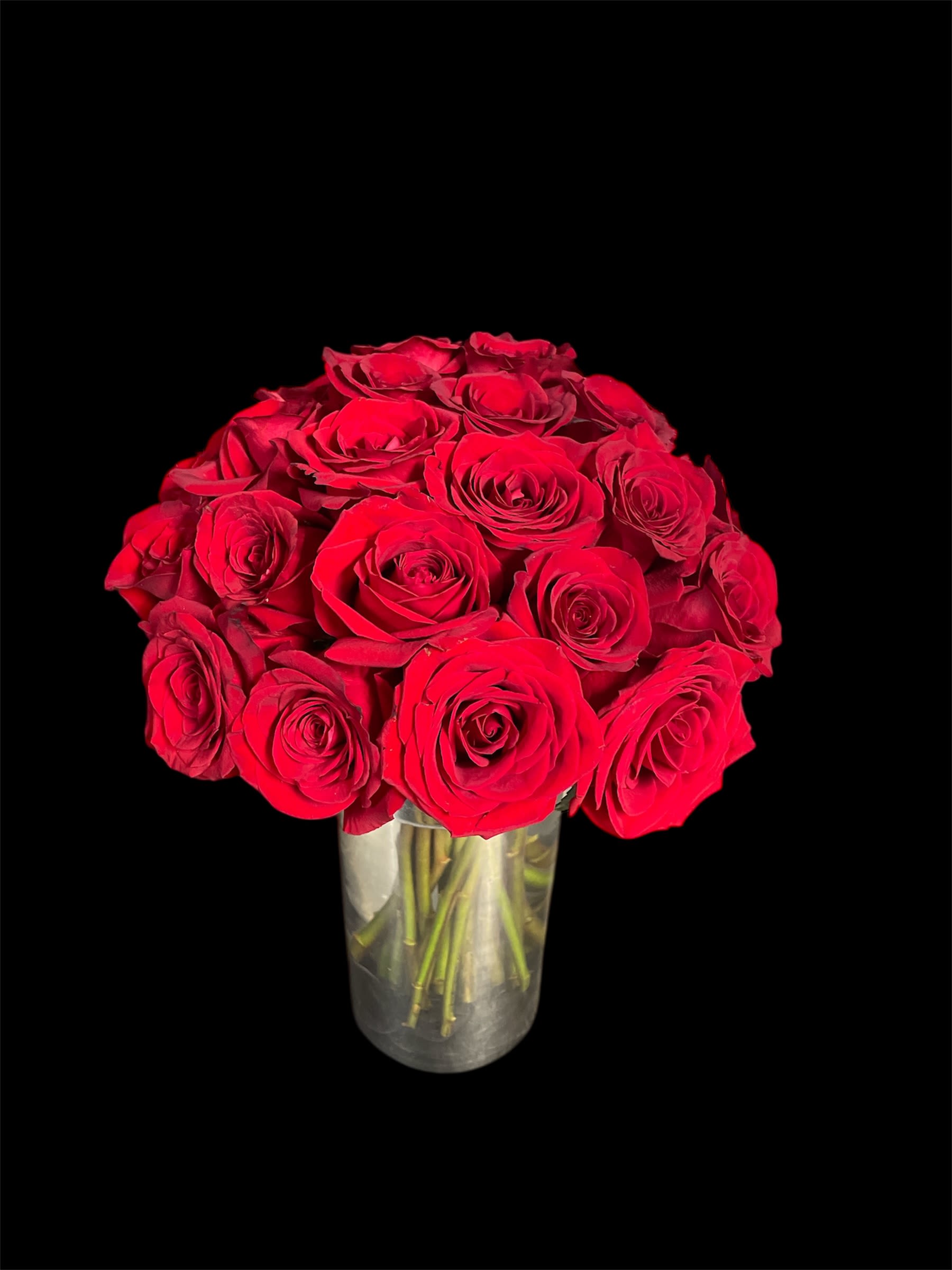 Scarlet symphony  - A timeless declaration of love and elegance, Scarlet Symphony features a stunning ensemble of premium red roses, meticulously arranged in a sleek glass vase. Each velvety bloom radiates passion, making it the perfect gift for romantic occasions, heartfelt gestures, or simply to elevate any space with classic beauty. Whether it’s for an anniversary, Valentine’s Day, or just because, this arrangement speaks the language of love with every petal.