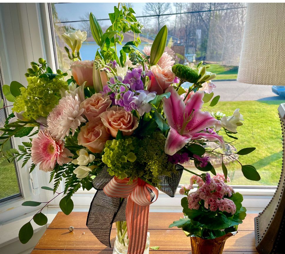 Floral Fantasy by Lotherington's - A gorgeous mix of colors, this large mixed arrangement makes a big impression with all its different textures and premium flowers. Featuring orange roses, lilies, bells of Ireland, pink gerbera daisies, hydrangea, and stock this arrangement makes a great anniversary or congrats gift.  Approximate Dimensions: 18"D x 25"H  ***Colors and blooms maybe substituted depending on season and availability ***  
