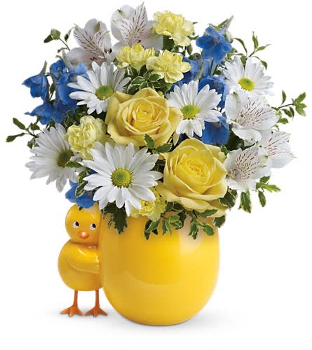 Yellow and blue flower arrangement in a chick-shaped vase