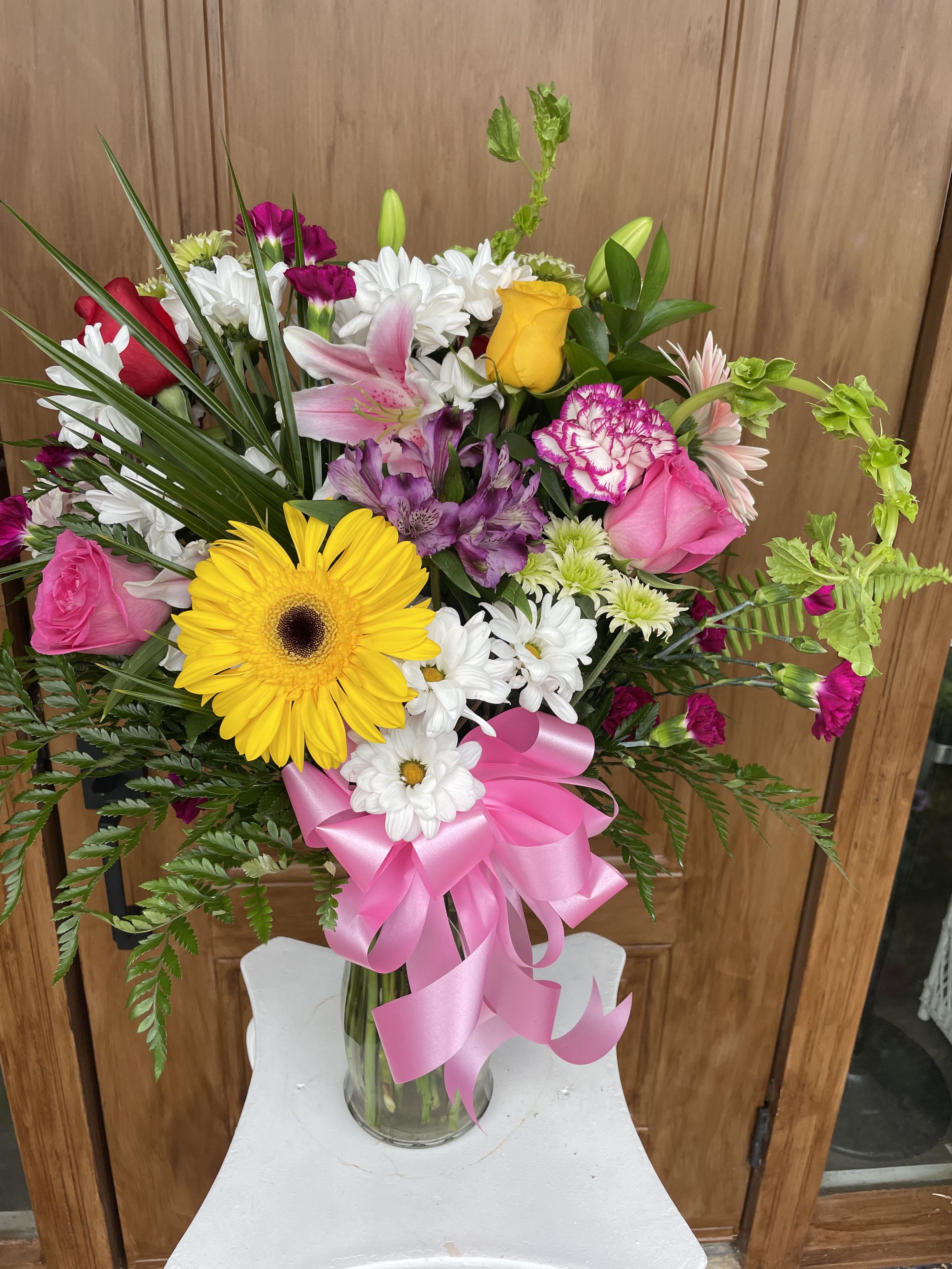 Polished in Pink by Lotherington's - A beautiful vase arrangement, featuring pink lilies, white and pink and yellow roses, and more, this arrangement is the perfect all-occasion gift. this arrangement is a great option for an early birthdays and well wishes!  Approximate Dimensions: 10''D x 13''H