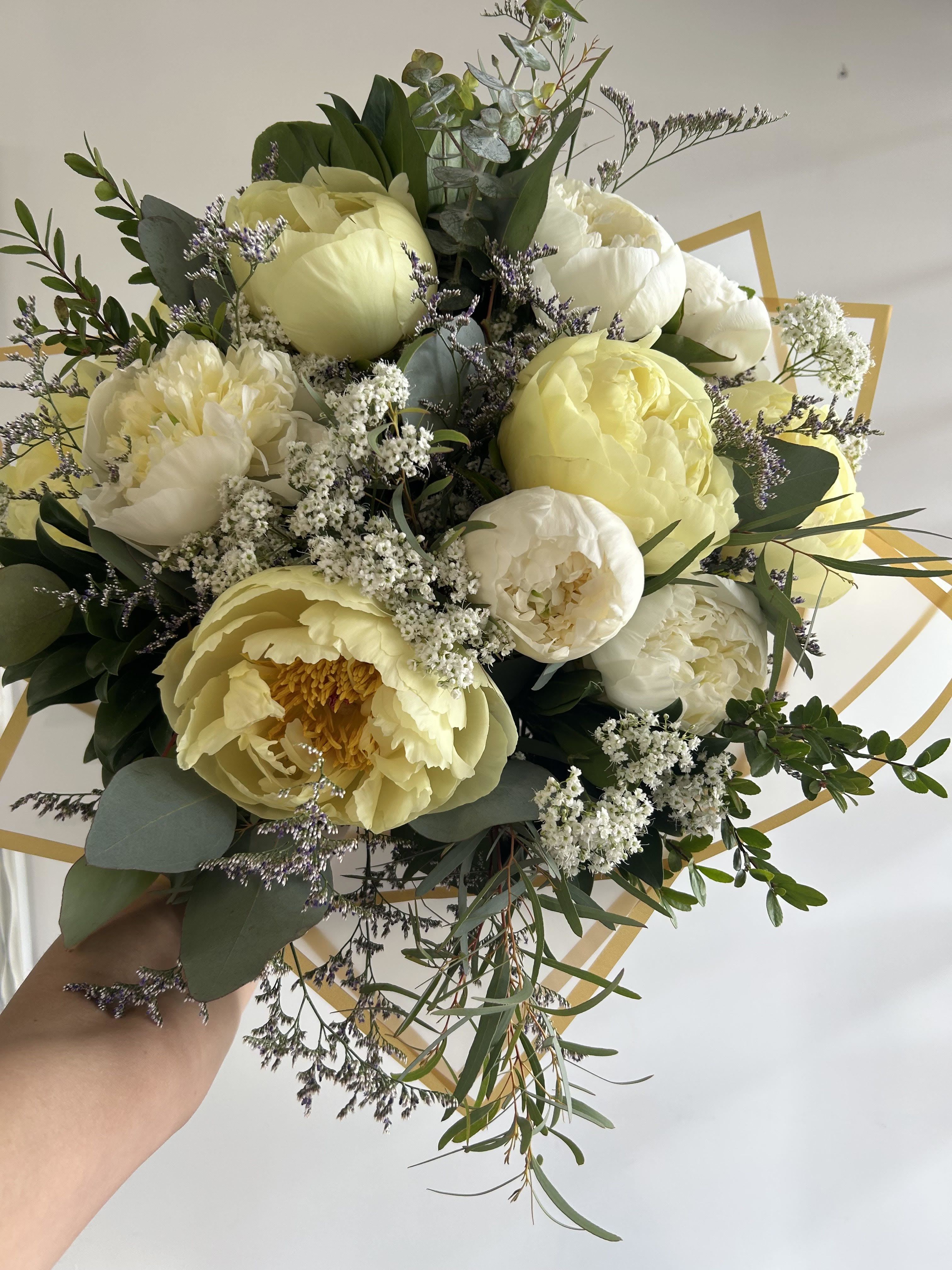 Peony Signature Hand-tie - A charming hand-tied bouquet featuring soft peonies blended with premium seasonal blooms and lush foliage. Designed with a balanced mix of colors and textures, this bouquet brings a fresh, elegant, and romantic feel perfect for birthdays, anniversaries, celebrations, or simply brightening someone’s day. Wrapped beautifully for a timeless and sophisticated presentation.