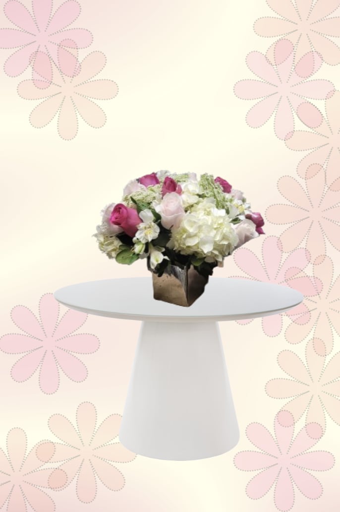 Pink-y Promise - Bright pink roses take center stage in this Pink-y Promise flower arrangement, a birthday bouquet and anniversary gift that reads fresh, feminine, and joyful. The compact, rounded design in a dark square vase creates a polished, decorative look that will make the person you're celebrating feel truly seen-perfect for spring occasions, a thoughtful "thinking of you," or a cheerful congratulations.  A lush cluster of bright pink roses pairs with creamy white hydrangeas and delicate white accent blooms, balanced by soft green foliage for a gentle contrast. The low-profile, pedestal-ready shape sits neatly on a square vase, ideal for a dining table, desk, or entryway without blocking conversation. Sizes and care: displays as a compact arrangement meant for immediate enjoyment-refresh water daily, trim stems every few days, and keep away from direct heat to prolong vibrancy.