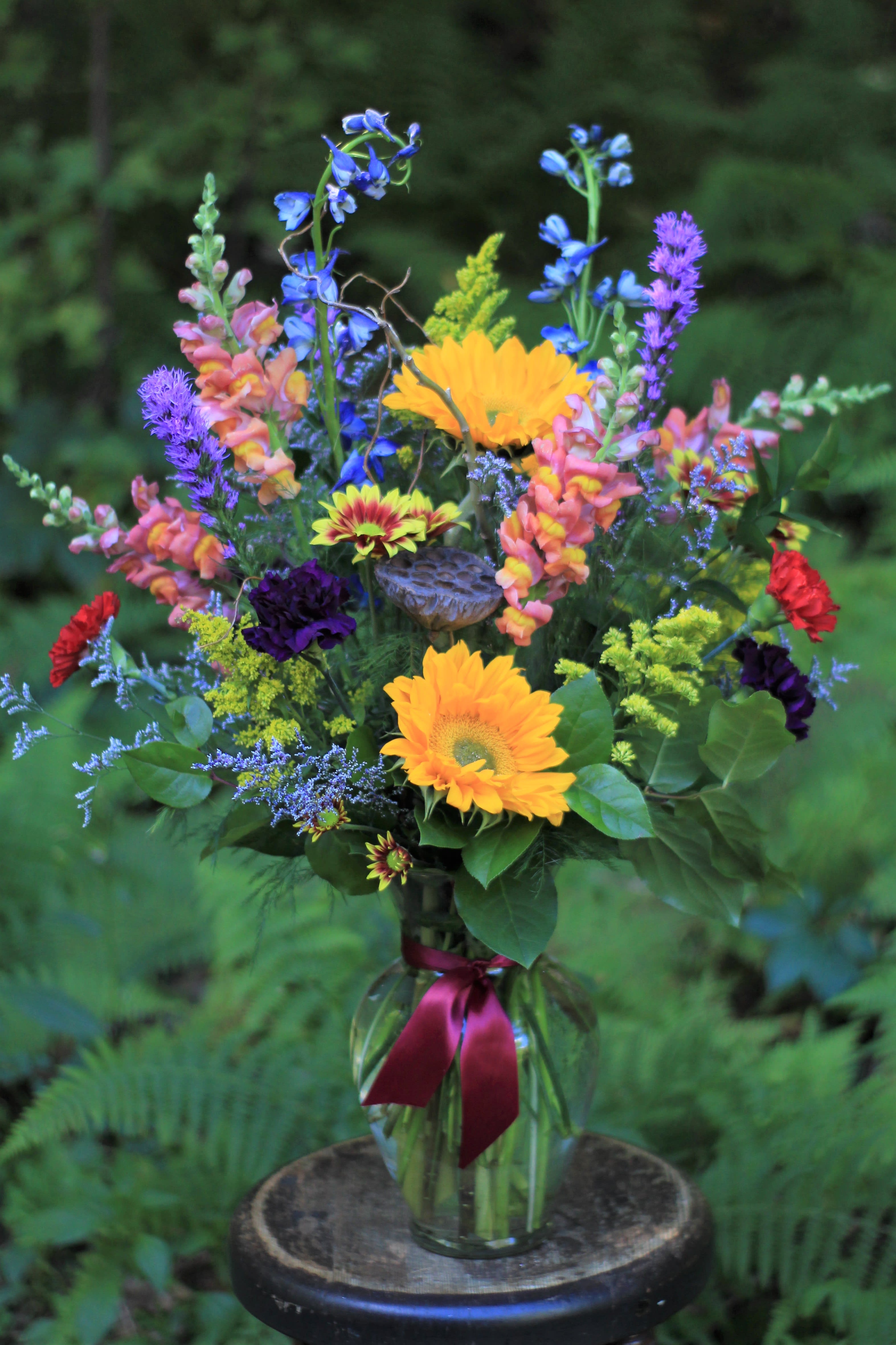 Mixed bouquet in a glass vase with bright yellow and purple flowers