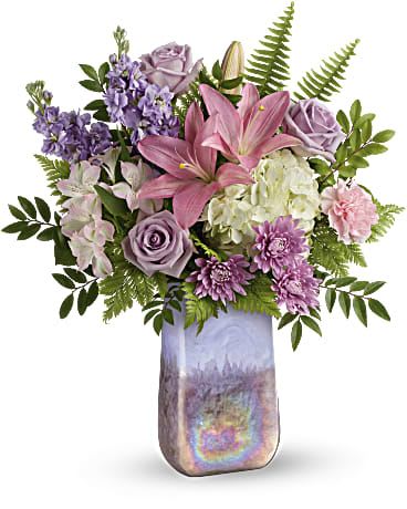 Glass Grandeur Bouquet - Make her feel grand with this glorious gift! Pastel-hued roses and lilies look magnificent in this hand-blown art glass vase with swirling iridescent finish.