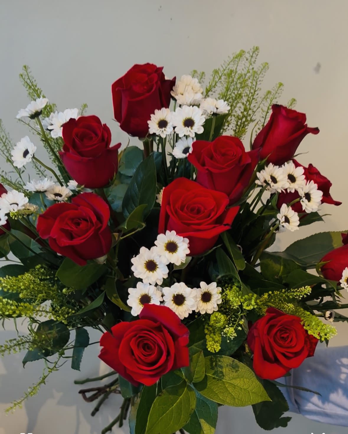 NCHS Graduation Bouquet - Mark this milestone with deep red roses clustered with cheerful white daisy‑like blooms make this graduation bouquet a classic, heartfelt choice to celebrate a graduate.    