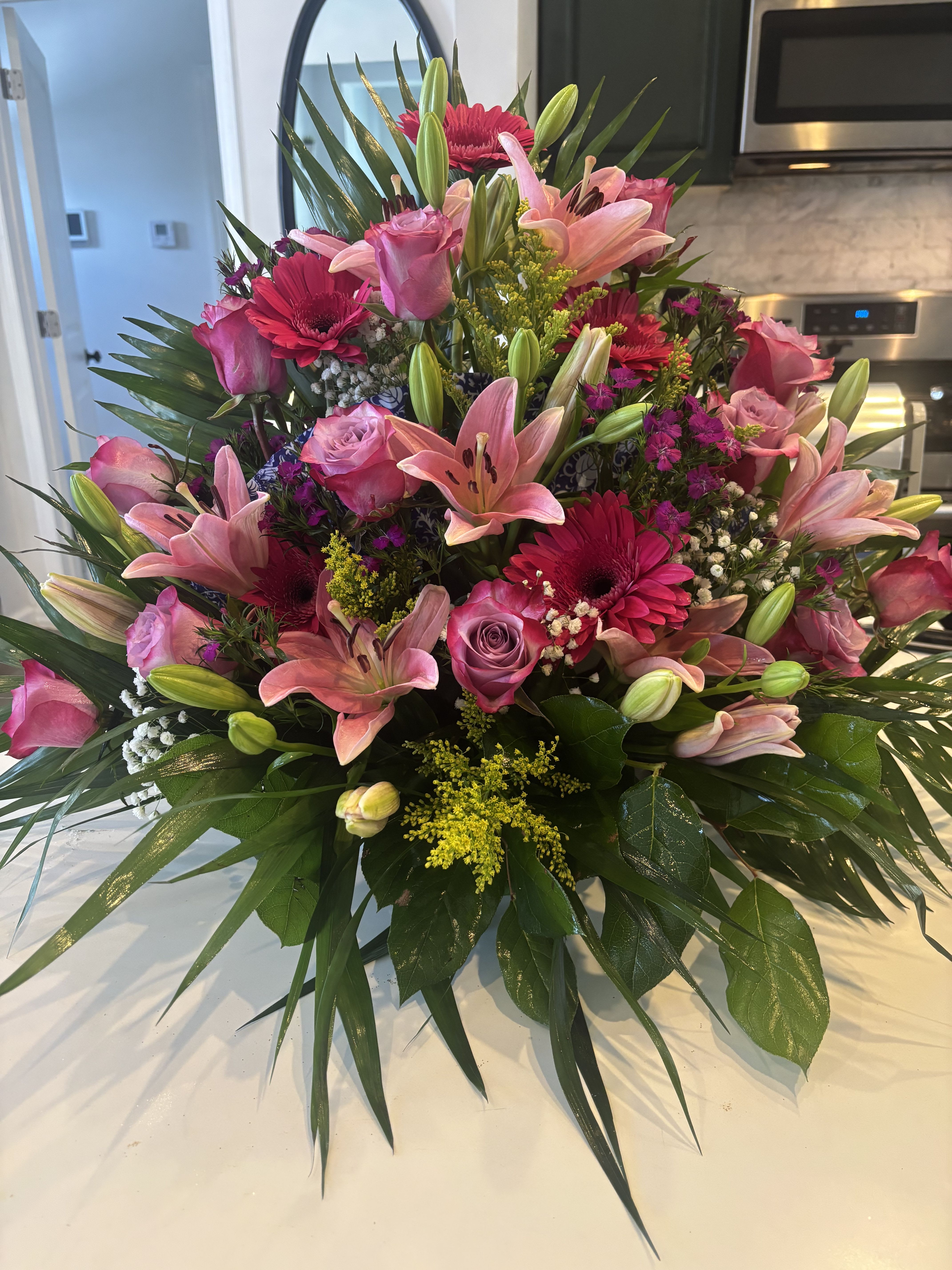 Rick’s Fan bouquet  - Mix floral arrangement with FAN in between flowers. 
