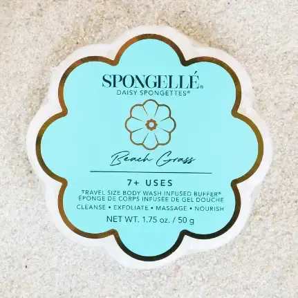 Beach Grass Daisy Spongette Soap Sponge - A travel-size flower-shaped body wash sponge designed like a daisy brings a crisp, spa-fresh touch to everyday self-care and makes a cheerful birthday or "just because" gift. The Beach Grass Spongette pairs a light blue and white graphic design with clean black text and a simple outlined flower motif, giving it a fresh, casual look that complements floral bouquets or a curated gift set for Mother's Day or to say "thank you."  The compact package includes a petal-edged Spongette and nourishing body wash in a travel-friendly format - accepted on all airlines and perfect for trips, gym bags, or a bedside pamper routine. Expect about seven or more washes per sponge; the texture of the soft petal curves gently exfoliates while lathering, so the person you're gifting it to will feel refreshed and cared for without fuss.  Pair this Spongette with flowers or other small treats to create a thoughtful gift set, or tuck one into a note as a simple, confident way to show appreciation. Its fresh blue-and-white styling keeps the presentation seasonally appropriate without feeling limited to a single occasion.