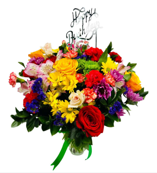 Colorful mixed bouquet with roses and daisies in a glass vase