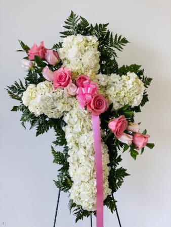 White floral standing spray with pink roses and ribbon