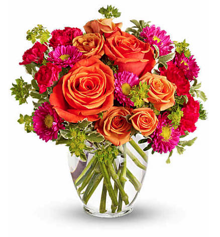 How Sweet It Is - A sweet treat any day of the week! Warm, rich colors of pink and orange are contrasted with fresh green - a welcome combination for any occasion. Send it to sweeten a best friend's birthday, say "hi" to mom, or delight your better half.  Light orange roses, orange spray roses, and matsumoto asters, hot pink miniature carnations and more are delivered in a lovely glass vase. Orientation: All-Around 