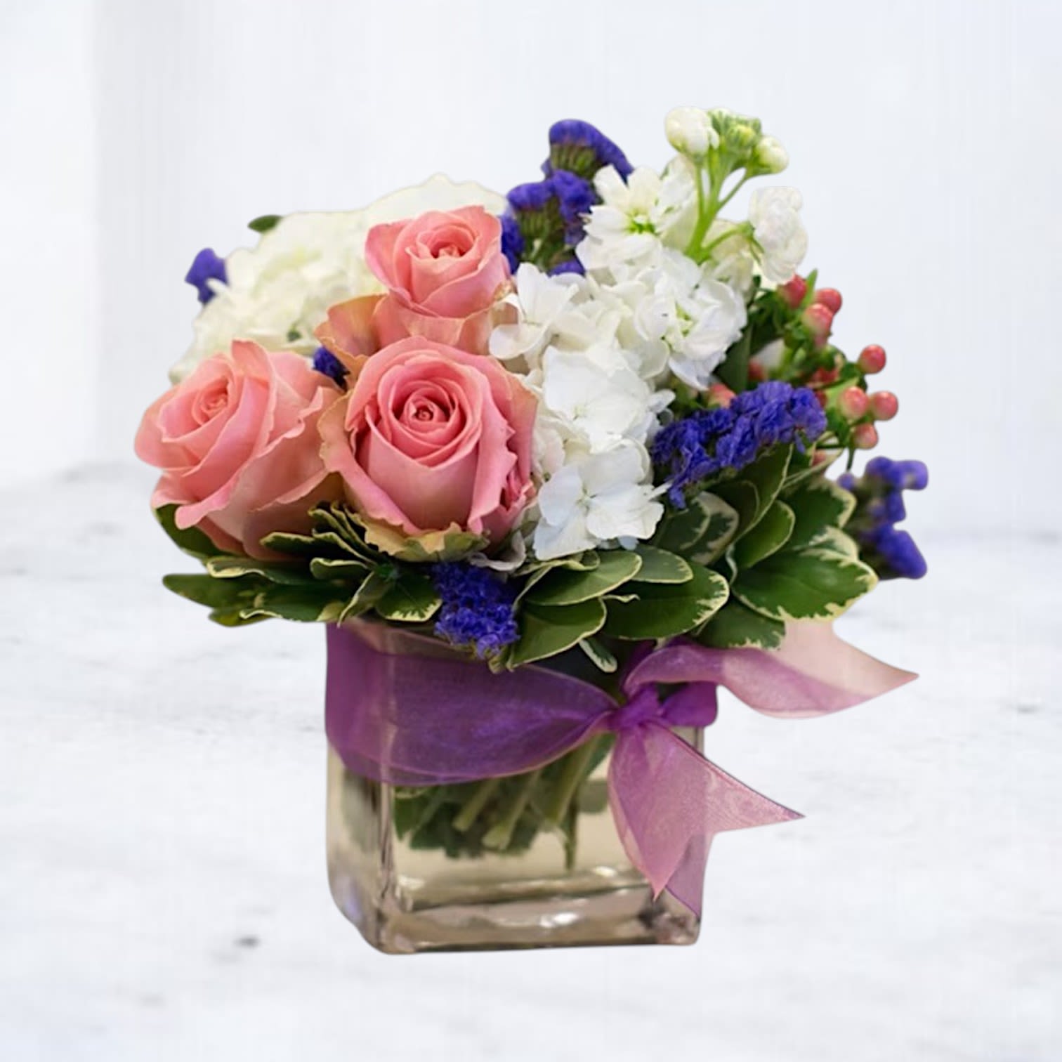 Jellybean - Jellybean is a sweet and cheerful floral arrangement featuring soft pink roses, white hydrangea, delicate seasonal blooms, and vibrant accents arranged in a clear glass cube accented with a coordinating ribbon. Inspired by colorful confections and joyful celebrations, this charming design is perfect for birthdays, new babies, thank-you gifts, get well wishes, or simply brightening someone's day.  Designed with premium seasonal flowers and a playful color palette, Jellybean brings a fresh, uplifting touch to any home, office, or special occasion. Its compact size and vibrant personality make it an easy favorite for everyday flower delivery.  Same-day flower delivery available in Magnolia, Montgomery, The Woodlands, Conroe, Spring, Tomball, and surrounding Houston areas.