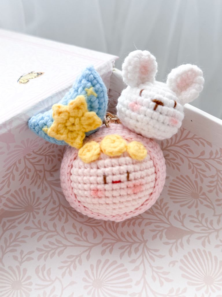 Crocheted bunny and star charms in a gift box