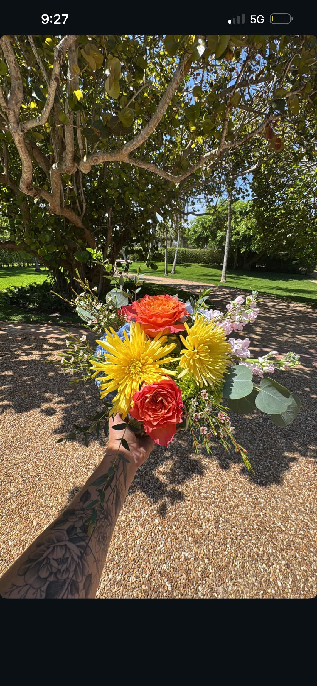 CFE115 - A low compact arrangement of orange, yellow, blue and pink high end blooms