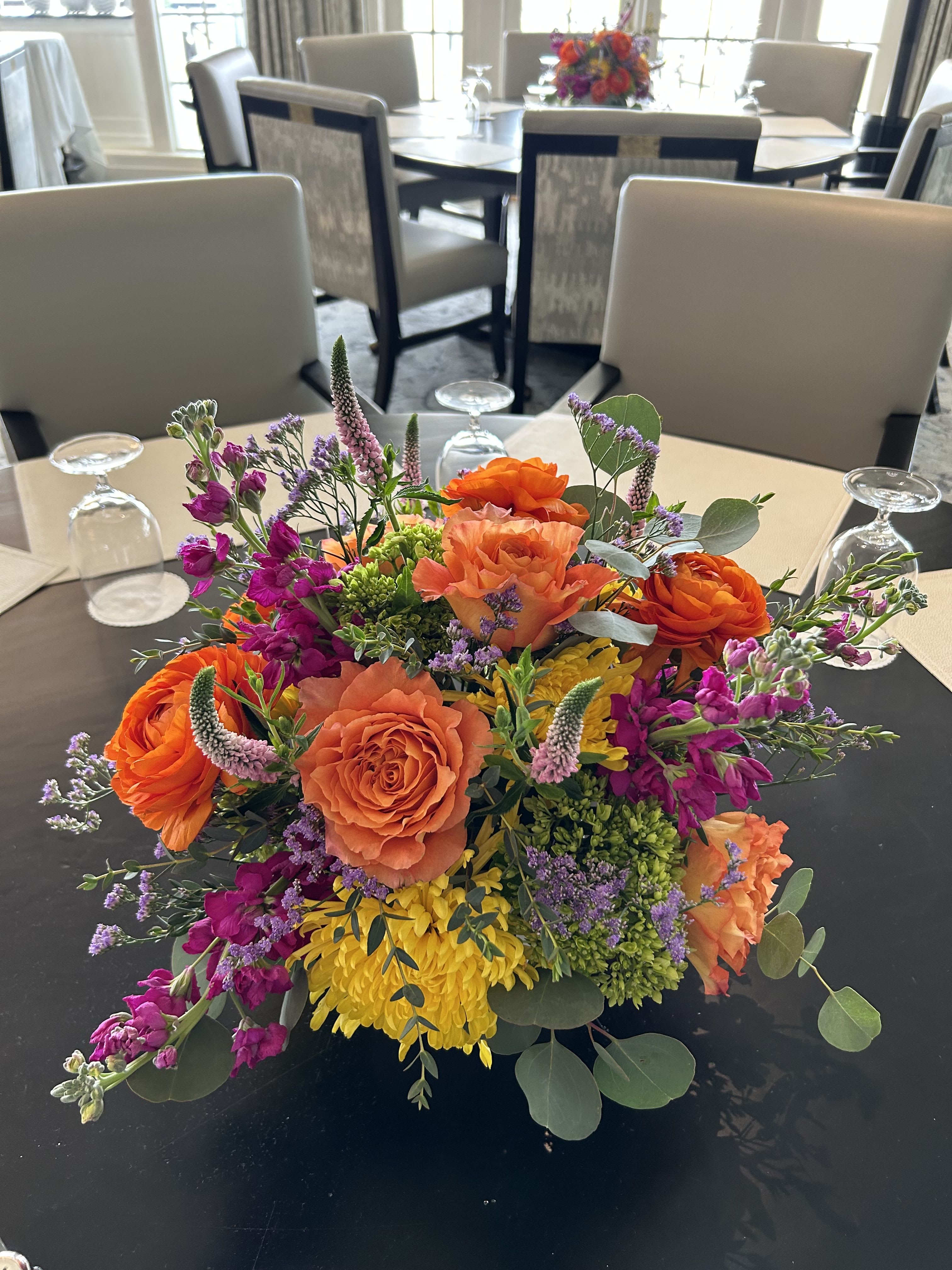 CFE122 - A low compact arrangement of shades of pinks, yellows and oranges with beautiful flowers such as garden roses, stock, green hydrangeas and other high end blooms. 