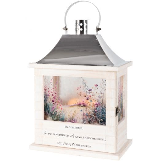 Carson Lantern - 12.5'' Wooden Slat In Our Home - Our Wooden Slat lanterns are made with quality wood with a stainless steel finish top. They come inscribed with sentimental quotes amid beautiful artwork on all four sides and a charming flameless LED candle. Suitable for hanging or use as a freestanding item. Recommended as an accent in floral arrangements for many occasions. They are weather friendly!   Lantern Reads: "In our home, love is nurtured, dreams are cherished and hearts are united"  W: 8.75" H: 12.5" D: 5.25"