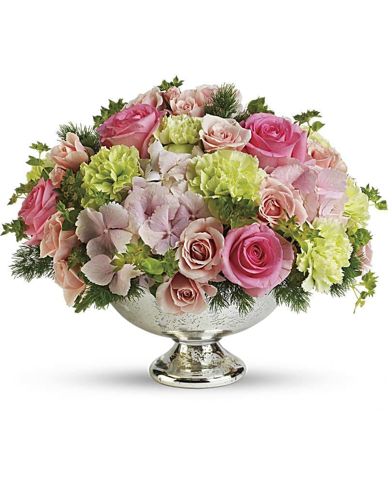 Garden Rhapsody Centerpiece - Blissful. Beautiful. A brilliant choice of wedding colors. Pink and green weddings are very chic indeed, requiring a centerpiece that is above and beyond. And this one is! A gorgeous garden of dazzling pink and green wedding flowers arranged in a Mercury Glass Bowl is sure to delight. Just say "I do," and we'll deliver! Pretty in pink hydrangea and roses, light pink spray roses and fresh green carnations are accented by buplerum and graceful fern and delivered in an exclusive silvery Mercury Glass Bowl.