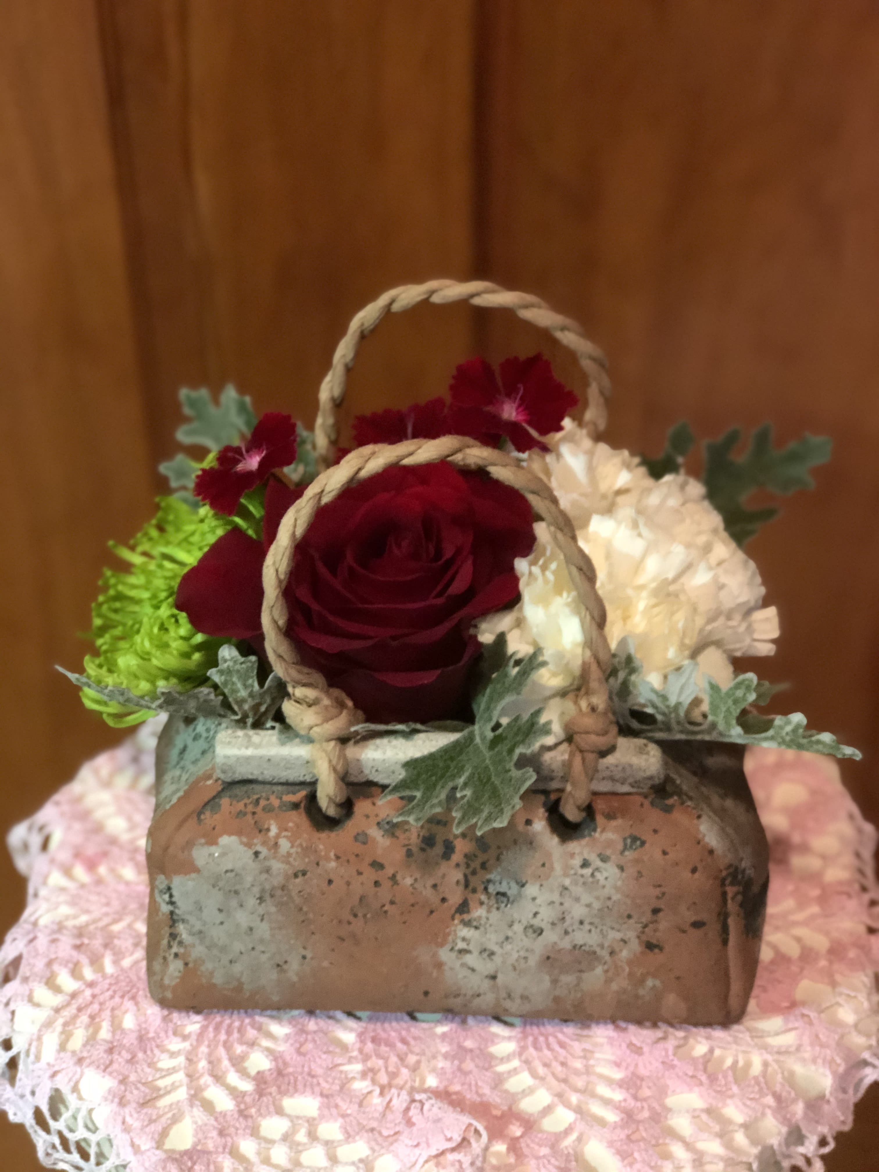 Small basket arrangement with red and white flowers