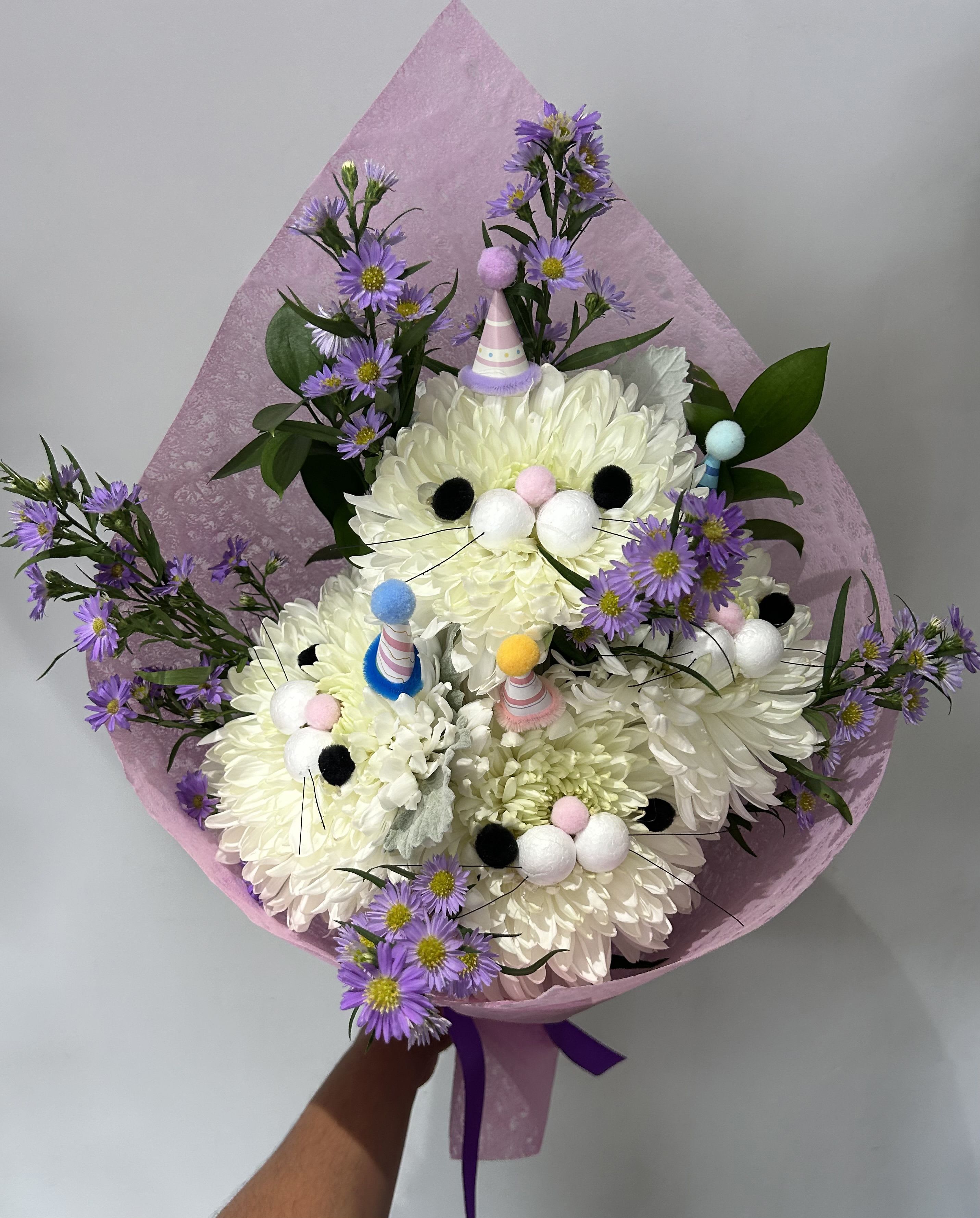 Party Cats - 4 Chrysanthemums decorated as party cats with filler, greens and arranged into a hand-tied bouquet (Chrysanthemums are mildly toxic to cats).