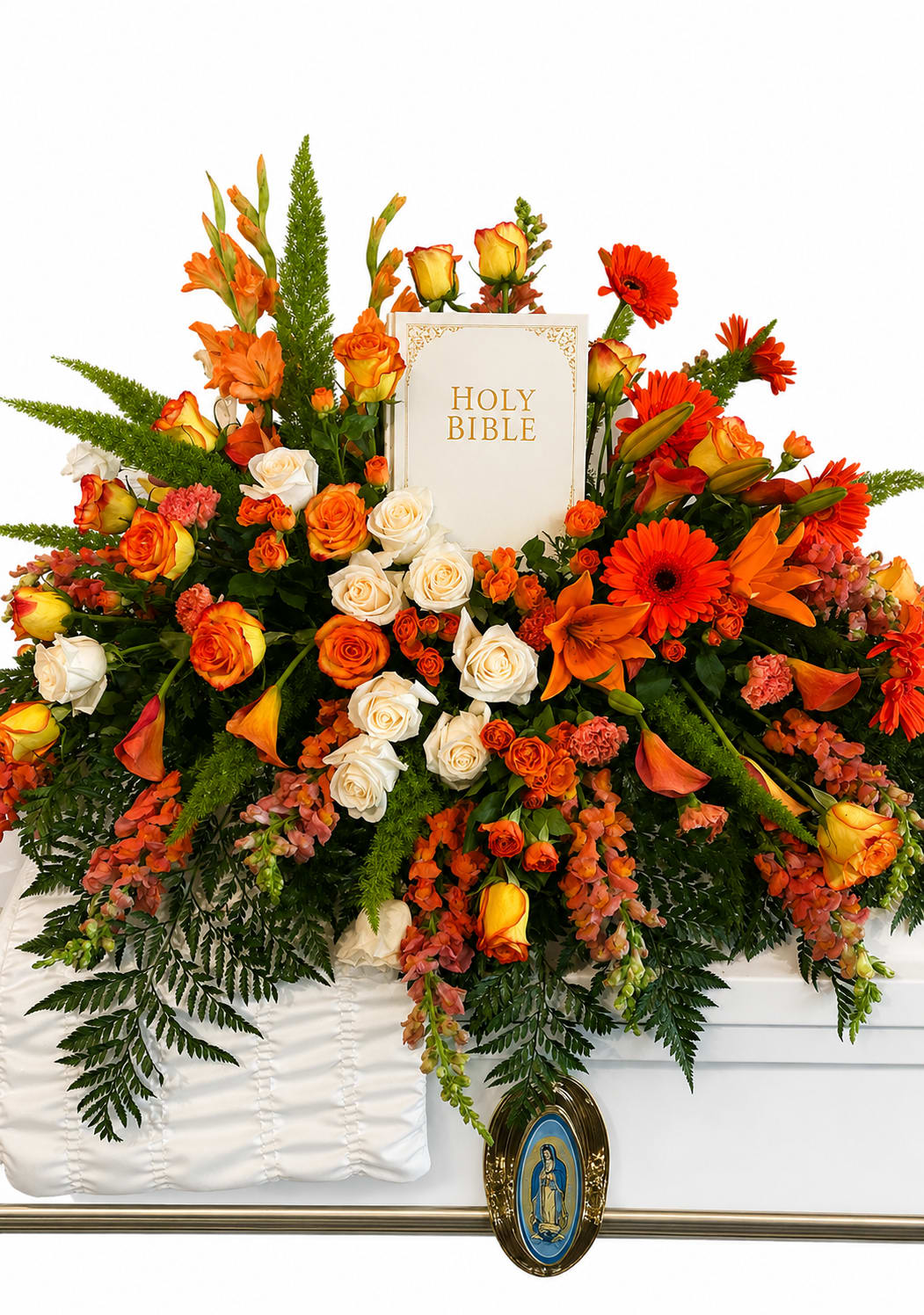 Heaven's Warm Embrace - A centered Holy Bible framed by a cascade of orange, white, pink, and green blooms gives this casket spray a reverent, uplifting presence perfect for a funeral or memorial service. As a casket top flower arrangement designed for sympathy, Heaven's Warm Embrace reads as both devotional and comforting-the warm oranges and soft pinks bring gentle brightness while white lilies and roses keep the tone solemn and respectful.  This full, symmetrical spray features large gerbera daisies, roses, lilies, calla lilies and clustered carnations arranged densely around the Bible, with mixed greenery for depth and contrast. The composition spills broadly over the casket top for a ceremonial scale; textures move from the sculpted calla lilies to the open faces of gerbera and the ruffled carnations, creating visual layers that carry across the entire piece.  Intended to honor a loved one, this arrangement is appropriate for clergy-led services or a visitation where a traditional, devotional tribute is desired. Sized to cover the casket front-to-back, it arrives ready to place on top of a white casket and requires no special care once arranged for the service.
