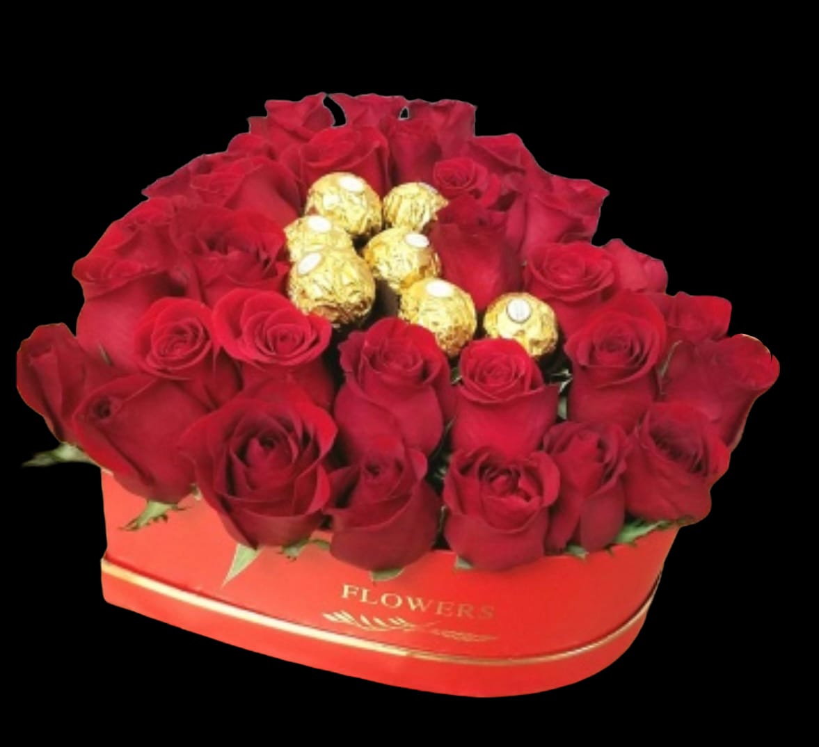 Red roses arranged in a heart-shaped box with gold-wrapped chocolates in the center