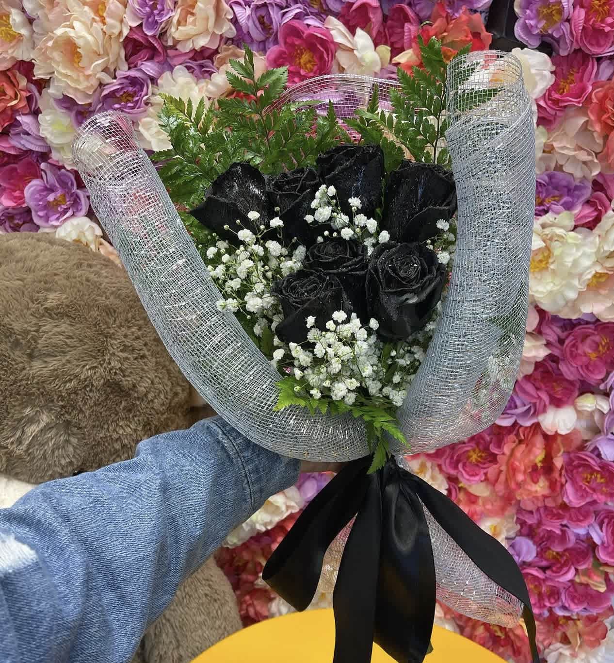Bouquet of black roses with baby's breath in silver mesh wrap