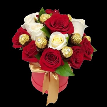 Red and white roses with gold-wrapped chocolates in a pink box