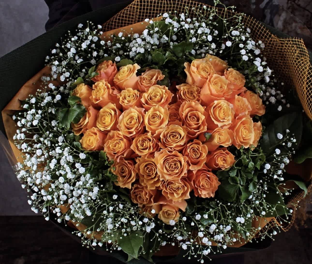 Bouquet of orange roses with white baby's breath