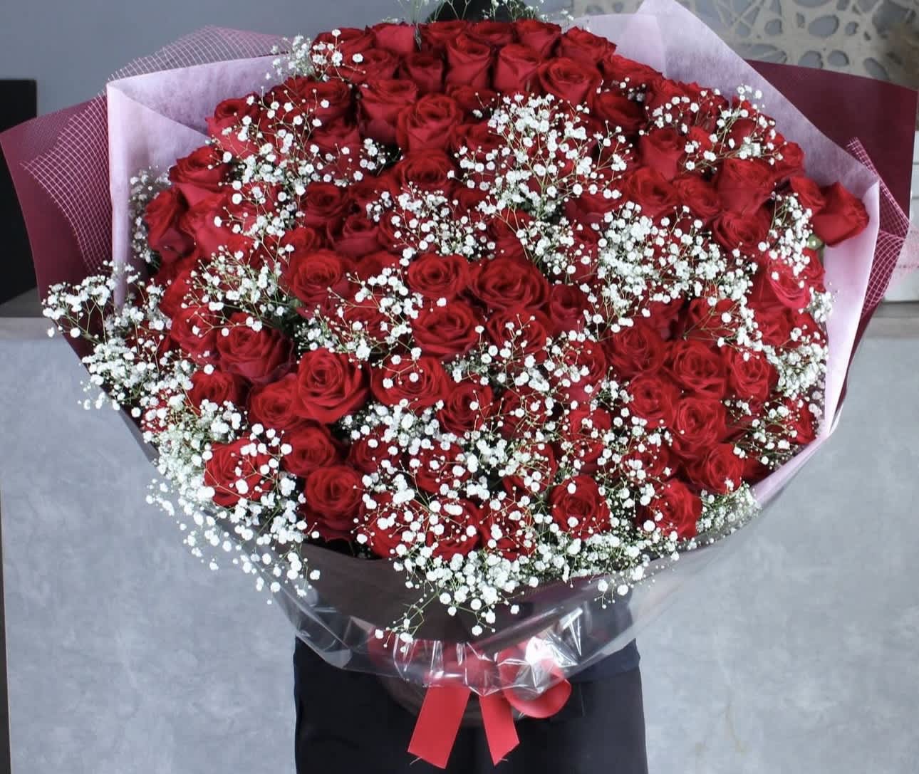 Large bouquet of red roses with white baby's breath