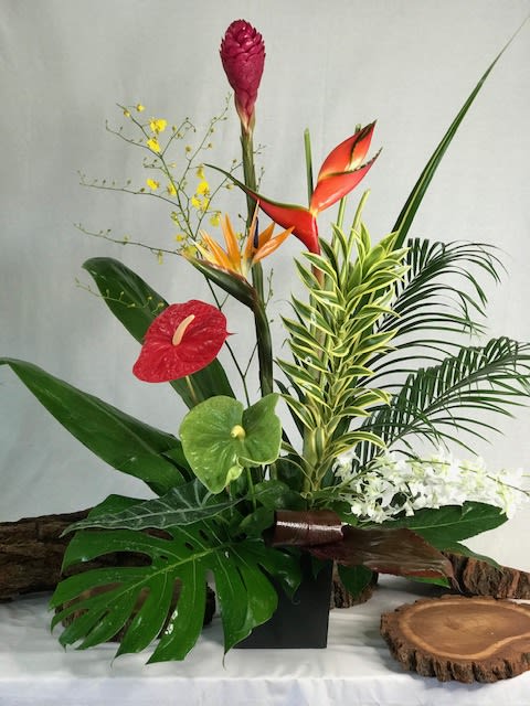 Tropical floral arrangement with red anthuriums and orange bird of paradise