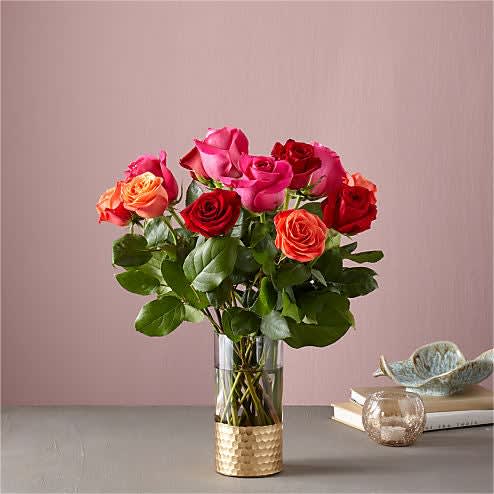 Bouquet of pink and red roses in a clear glass vase