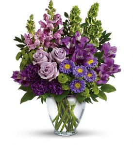 Purple mixed bouquet in a clear glass vase